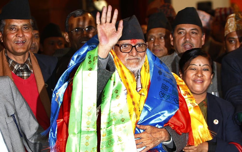Nepal`s newly elected Prime Minister Sushil Koirala waves to the media at the Constitution Assembly Hall in Katmandu, Nepal.