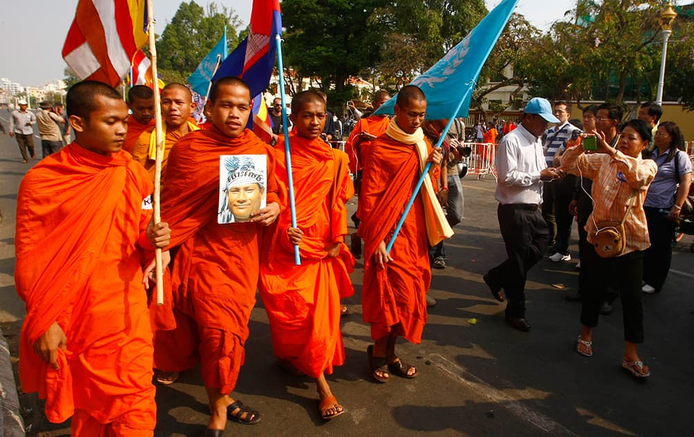 Cambodian Buddhist monks march with villagers from Boeung Kak lake community to call for the release of 23 detainees in front of the Ministry of Justice in Phnom Penh, Cambodia.