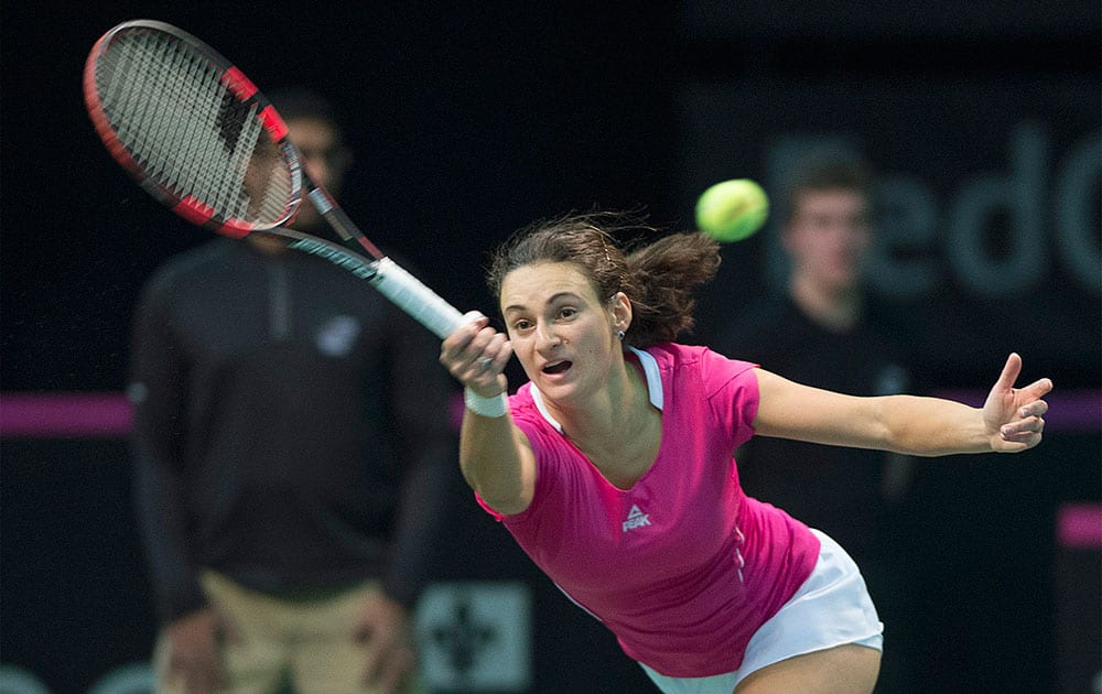 Serbia`s Vesna Dolonc returns the ball to Canada`s Eugenie Bouchard during a Federation Cup tennis match in Montreal.
