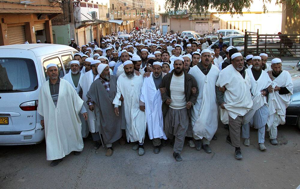 Men attend to a peaceful walk to protest the death of two Berber men, in the desert city of Ghardaia. Ghardaia, on edge for more than a month, is split between Algeria`s Mozabites, members of North Africa`s original Berber inhabitants and followers of the rare Ibadi sect of Islam on one hand, and the majority Malekite Arabs.