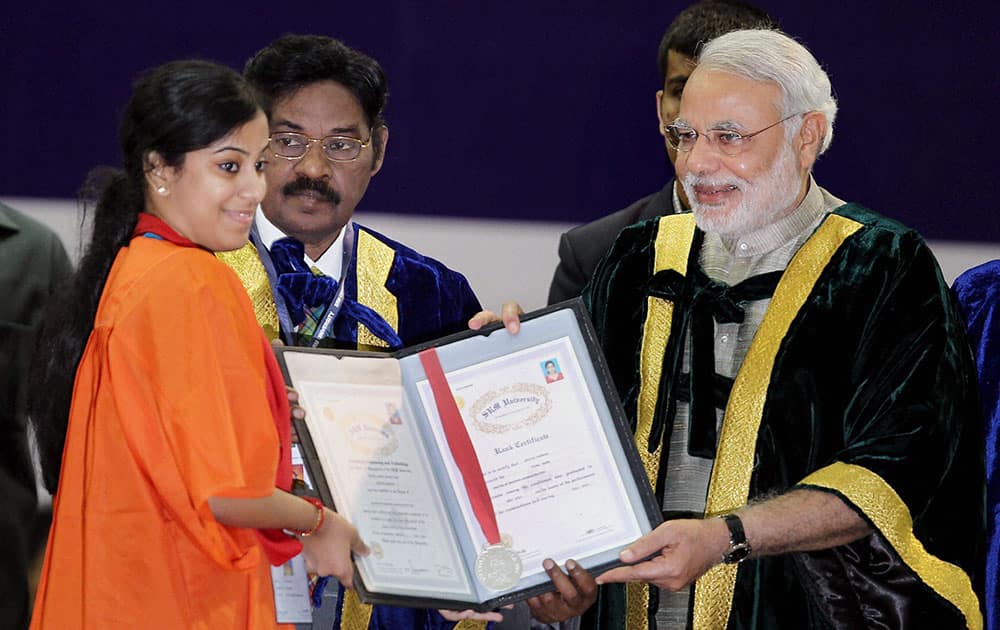 BJP Prime Ministerial candidate and Gujarat Chief Minister Narendra Modi presenting certificate to a student as SRM University Chancellor, Pachamuthi looks on during the ninth Convocation of SRM University at Kattankulathur, near Chennai.