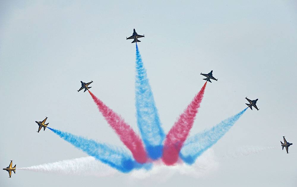 The T-50 jets of Republic of Korea Air Force aerobatics team, the Black Eagles, perform a maneuver during a media preview for the upcoming Singapore Air Show.