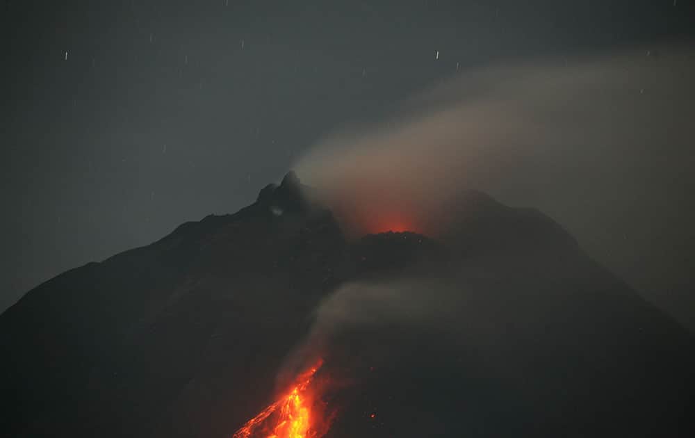 Mount Sinabung spews hot lava as seen from Jeraya, North Sumatra, Indonesia. The rumbling volcano in western Indonesia continues unleashing fresh clouds of searing gas.