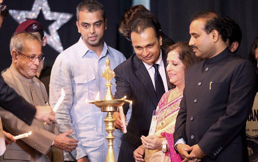 President Pranab Mukherjee along with Minister of State for Communications and IT Milind Deora and industrialist Anil Ambani lighting the lamp at the Diamond Jubilee celebration of Kishanchand Chellaram College in Mumbai.