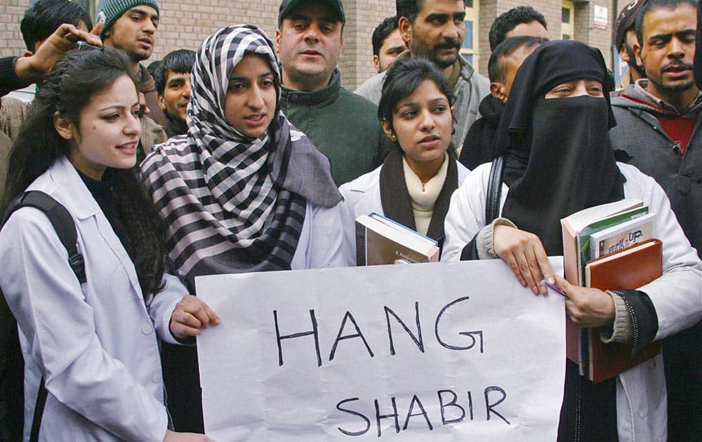 Medical and paramedical staff of SMHS hospital shout slogans during a protest against former Jammu and Kashmir Health Minister Shabir Ahmad Khan in a molestaion case, in Srinagar.