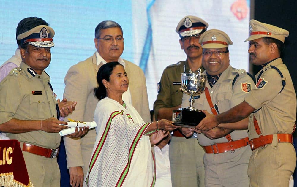 West Bengal Chief Minister Mamata Banerjee presents medal to police officers at West Bengal Police Award Function in Kolkata.