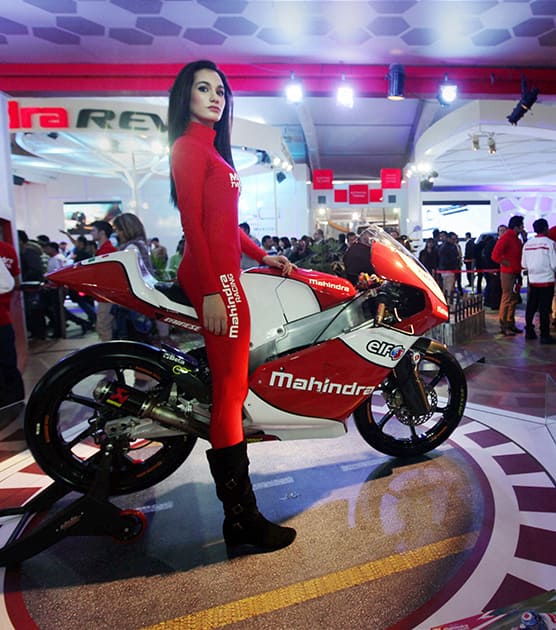 A model poses with a Mahindra bike on display at the 12th Auto Expo that was opened for the public in Greater Noida.