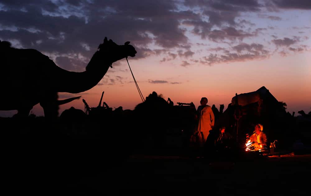 Camel herders warm themselves at a bonfire at the annual Nagaur cattle fair, in Nagaur, the western Indian state of Rajasthan. The eight-day Nagaur Cattle Fair is one of the most popular and second largest cattle fair in the state.