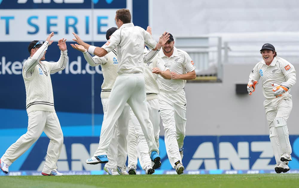 New Zealand’s Tim Southee celebrates with his team mates after dismissing India’s Virat Kohli for 4 on the second day of the first cricket test at Eden Park in Auckland, New Zealand.