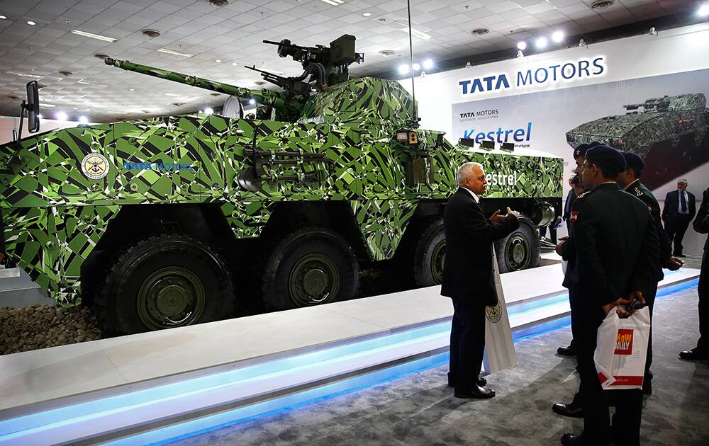 A Tata Motors company exhibitor explains to a group of Indian army personnel about the newly launched Kestrel, a multi-wheeled armored amphibious vehicle, at the 8th International Land and Naval Defense System exhibition, in New Delhi.