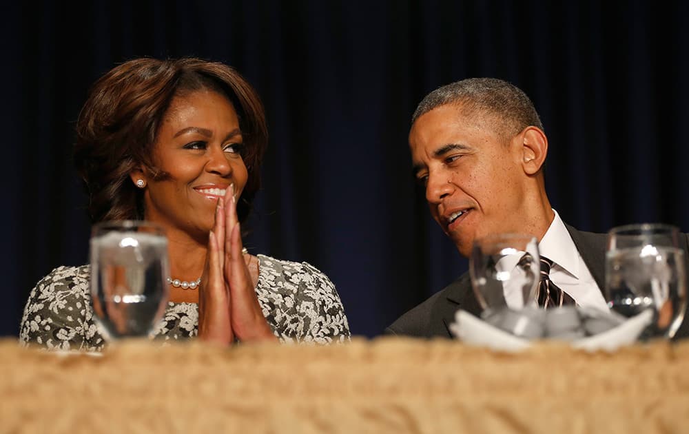 President Barack Obama and first lady Michelle Obama talk during the National Prayer Breakfast in Washington.