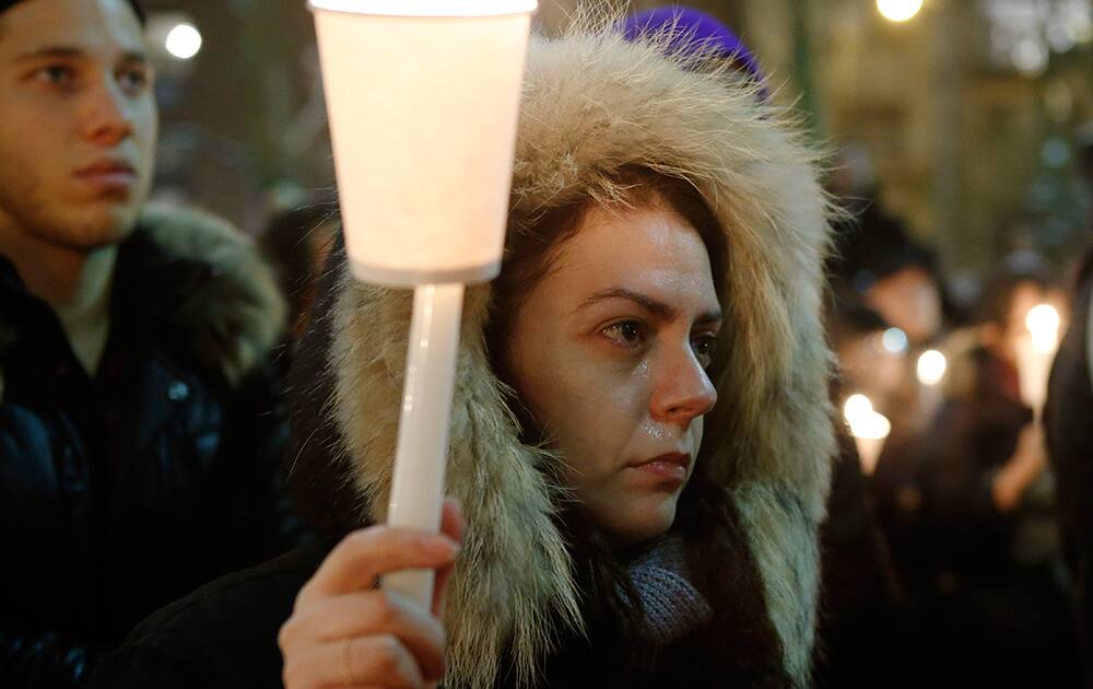 A woman sheds tears during a candlelight vigil for actor Philip Seymour Hoffman at the Bank Street Theater, home of the Labyrinth Theater Company, in New York. Hoffman died Sunday of a suspected drug overdose.