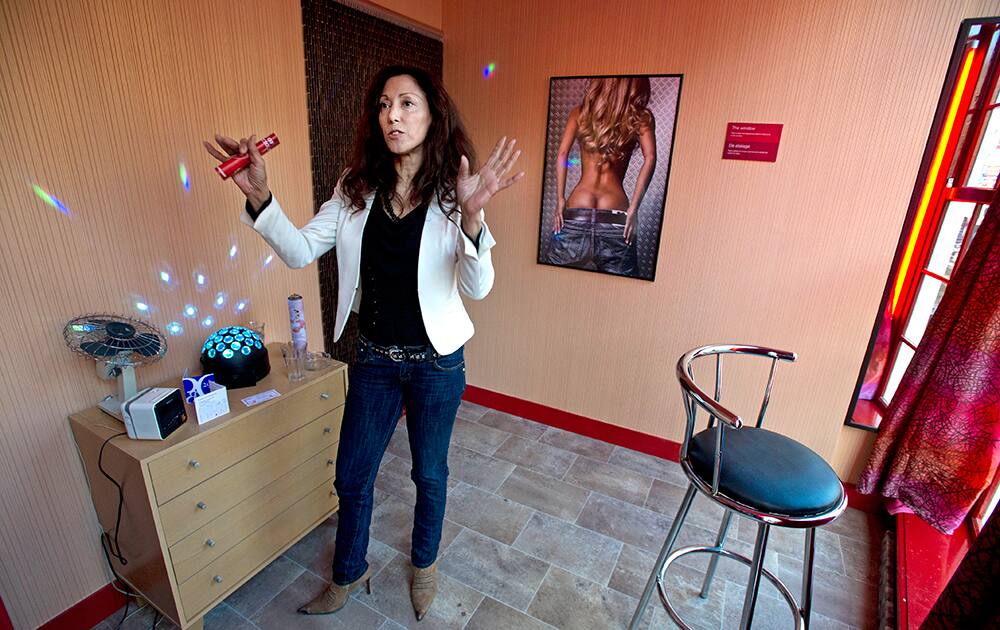 Ilonka Stakelborough, an escort who heads a sex-workers union called `the Geisha Institute,` talks to an AP reporter during an interview in a mock-up of a prostitution window at the `Red Light Secrets` museum in Amsterdam.