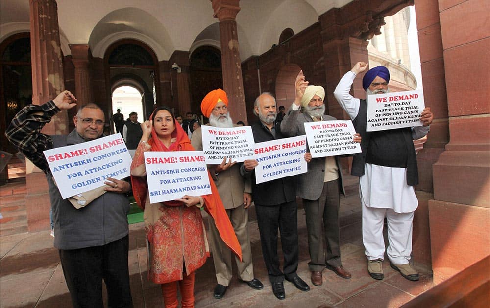 SAD members holding a protest against anti-Sikh attacks at Parliament House during the first day of the extended winter session in New Delhi.