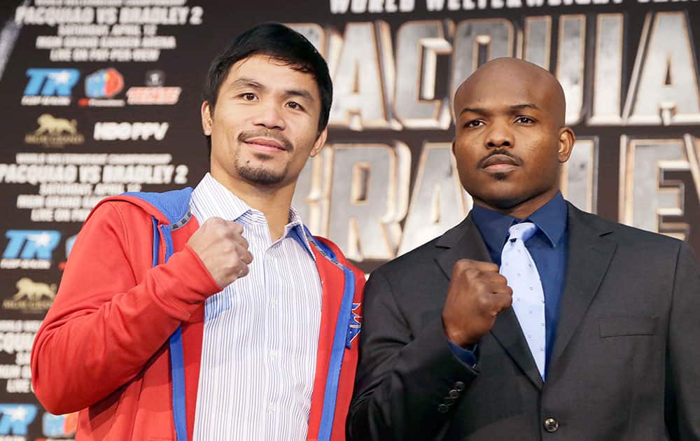 Manny Pacquiao, left of the Philippines, and Tim Bradley pose at a news conference to promote their upcoming WBO welterweight championship boxing rematch in Beverly Hills, Calif.