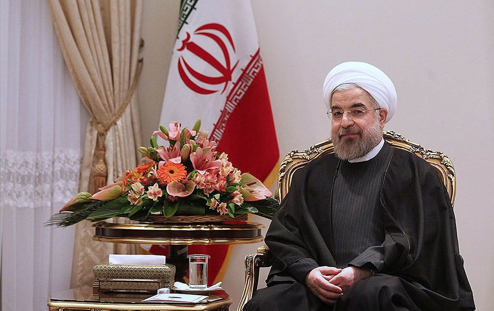 This photo released by the official website of the office of the Iranian Presidency, President Hassan Rouhani sits in a meeting with Swedish Foreign Minister Carl Bildt at the Presidency compound in Tehran, Iran.