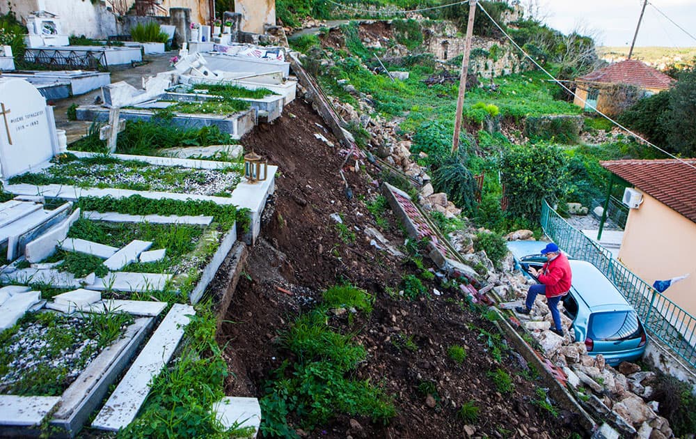 A man tries to approach a damaged cemetery after Monday`s strong earthquake in Lixouri, on the island of Kefalonia, western Greece.