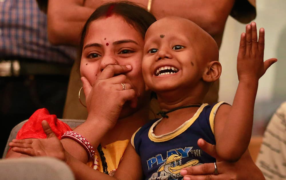 A child suffering from cancer reacts in amusement as he watches an event to mark World Cancer Day at the Tata Memorial cancer treatment and research center in Mumbai.