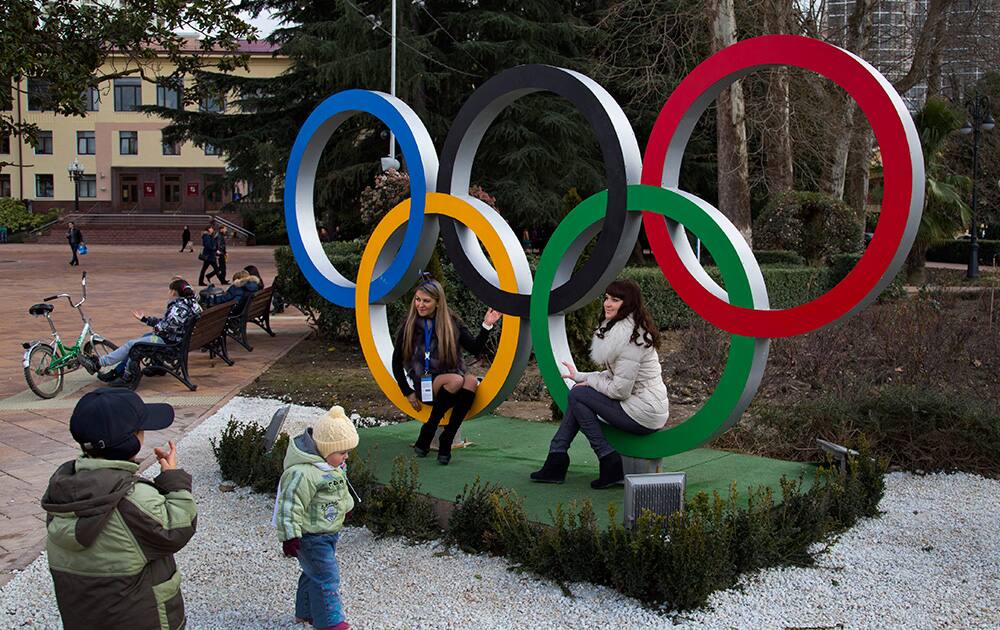 Russian women pose for snapshots next to Olympic rings in Sochi, Russia. The opening ceremony for the 2014 Winter Olympics will be held on Feb. 7, and the competition will run until Feb. 23.