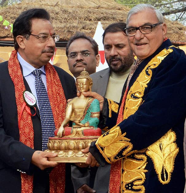 Haryana Chief Minister Bhupinder Singh Hooda is presented a memento by dy CM Francis D`Souza during inauguration of International Crafts Mela in Surjakund near Faridabad.