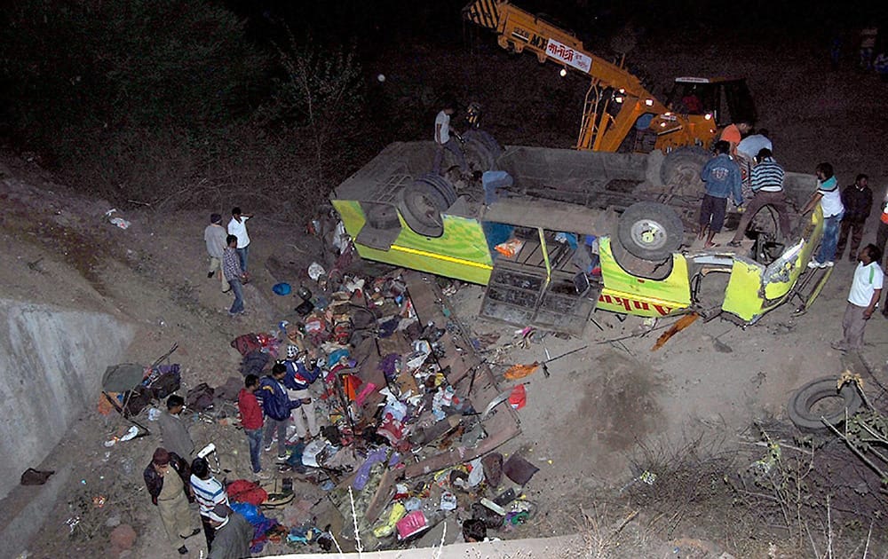 Rescue work is carried out after a tourist bus fell off a bridge on the Pune-Satara road near the Khambatki Ghat in Satara, Maharashtra.