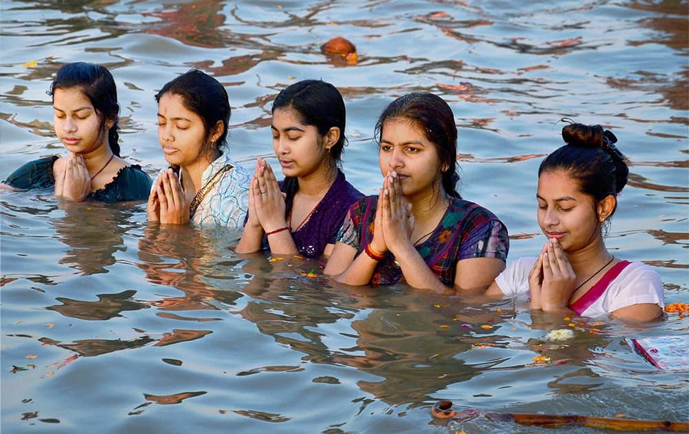 Devotees offer prayers in river Sangam on the occasion of Basant Panchami during the Magh Mela festival on Tuesday in Allahabad.