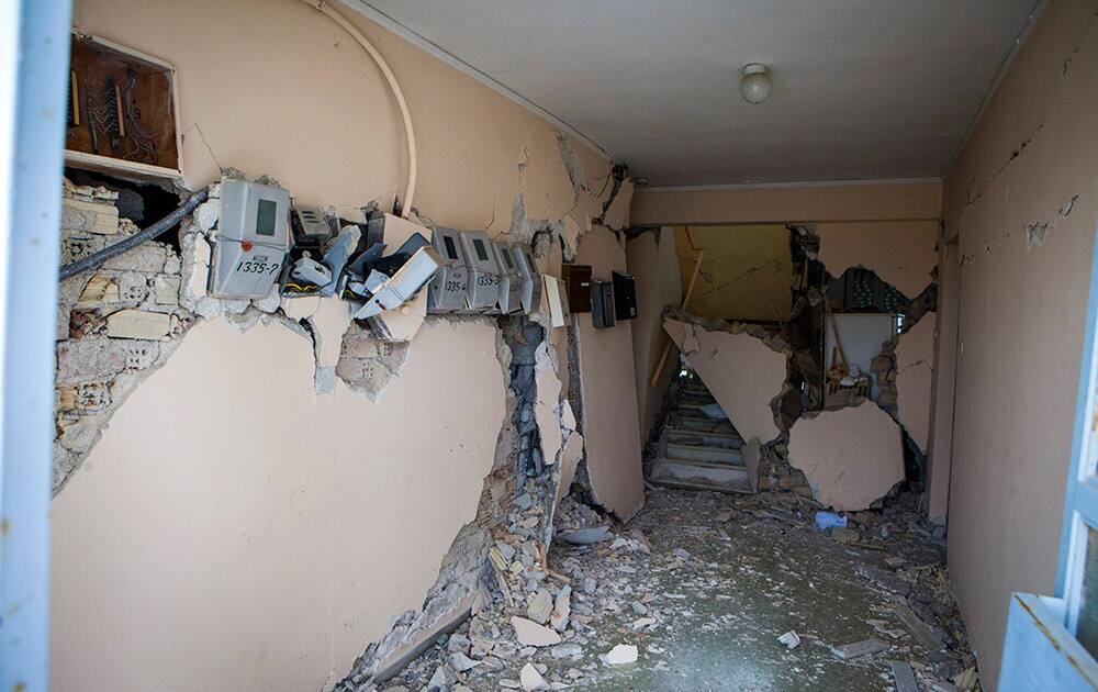 The entrance of a building is damaged after an earthquake in Lixouri on the island of Kefalonia, western Greece. A strong earthquake hit the western Greek island of Kefalonia before dawn Monday, sending scared residents into the streets just over a week after a similar quake damaged hundreds of buildings.