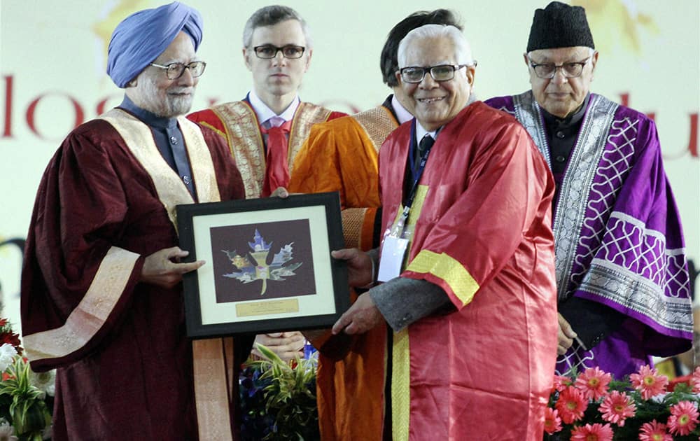 Prime Minister Manmohan Singh presents an award to a scientist at the 101st Indian Science Congress in Jammu on Monday. Union Minister Farooq Abdullah and Jammu and Kashmir Chief Minister Omar Abdullah are also seen.