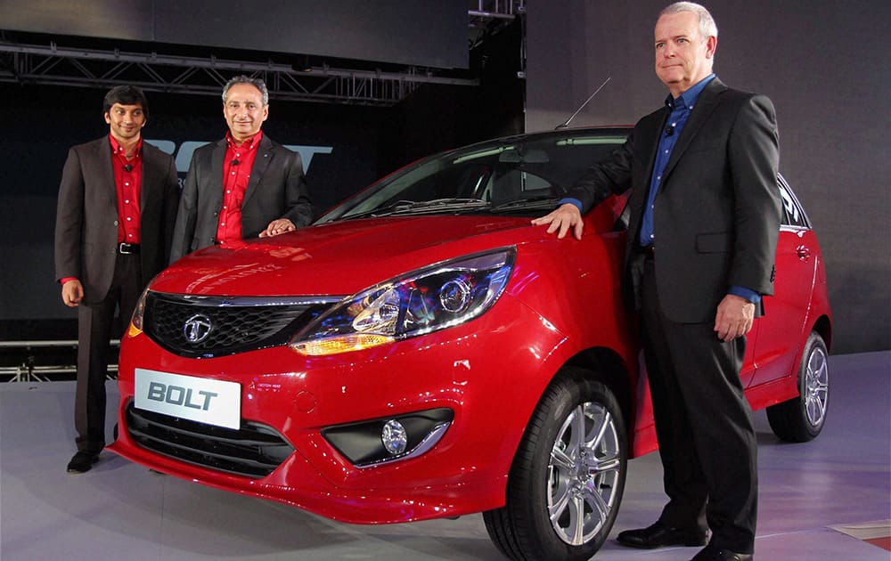 Tim Leverton (R), Chief of the advanced and product engineering department at Tata Motors, Ranjit Yadav, President, Passenger Vehicles, Tata Motors and race driver Narain Karthikeyan (L) at the unveiling of their new car `Bolt`, on Monday in New Delhi.