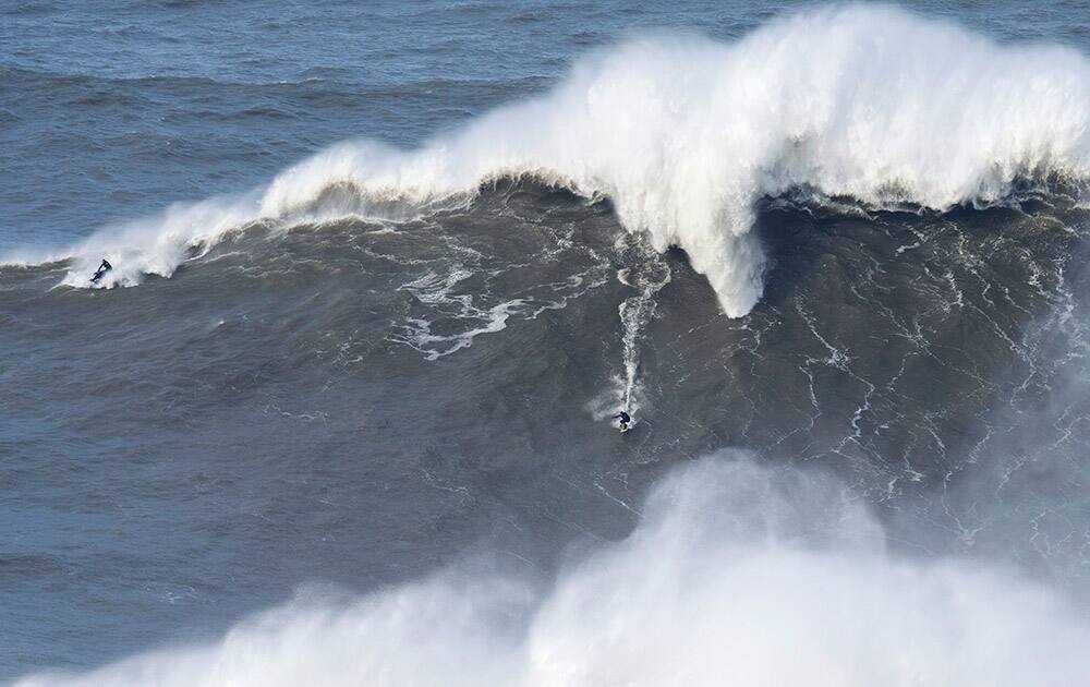 Andrew Cotton, from England rides a giant wave at Praia do Norte, north beach, in Nazare, in Portugal`s Atlantic coast.