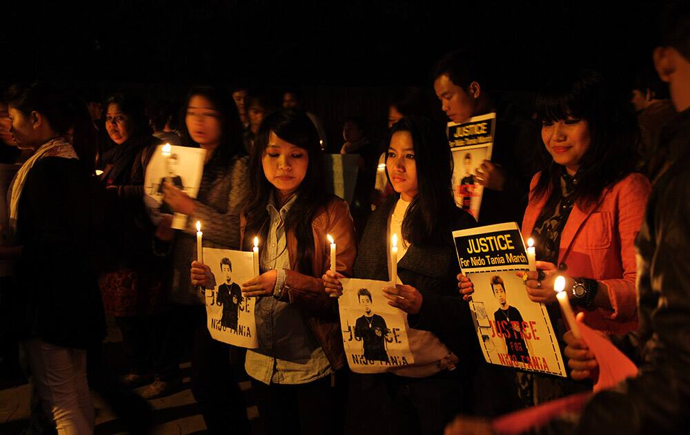 Students from India`s northeast and their supporters hold placards and candles during a protest in New Delhi.