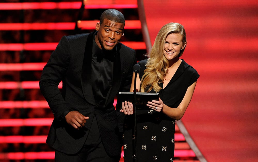 Carolina Panthers` Cam Newton, left, and model Brooklyn Decker speak on stage at the thirrd annual NFL Honors at Radio City Music Hall in New York.