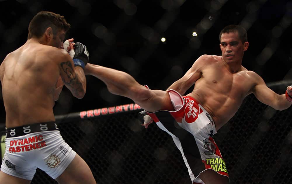 Chris Cariaso, right, and Danny Martinez fight during the third round of a UCF 169 flyweight mixed martial arts bout in Newark, N.J.