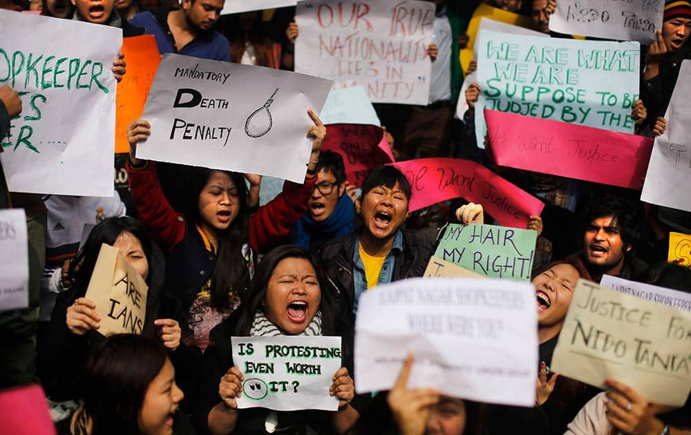 Protesters mostly students from northeastern states of India shout slogans during a protest in New Delhi.