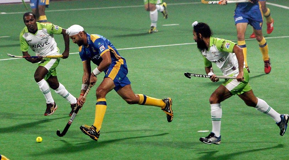 Jaypee Punjab Warriors Sandeep Singh and Delhi Waveriders player vie for the ball during the Hero Hockey India League, in New Delhi.