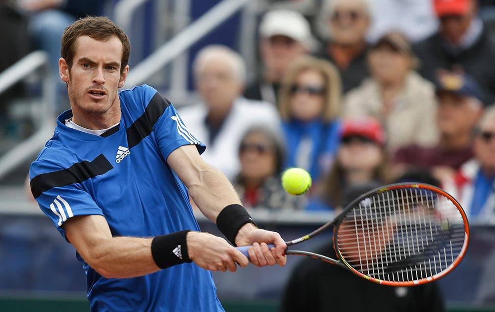 Britain`s Andy Murray hits a backhand return during his 6-1, 6-2, 6-3 victory over Donald Young, of the United States, in a Davis Cup tennis match.
