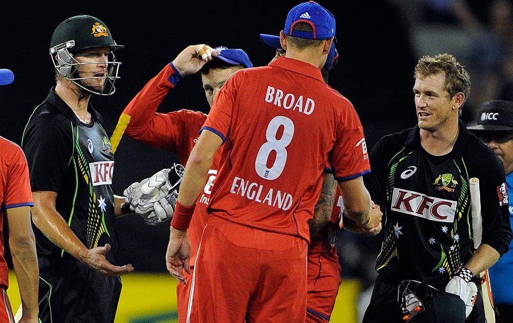 England captain Stuart Broad congratulates Australia`s George Bailey and Cameron White congratulate each other after after the T20 International cricket match at the Melbourne Cricket Ground in Melbourne, Australia.