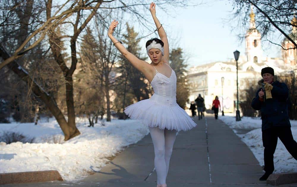 Ballet dancer Alexandra Portyannikova, with handcuffs on both hands and braving the frost of minus 20 C (- 4 F), dances taking part in a protest action on a square in Moscow, Russia.