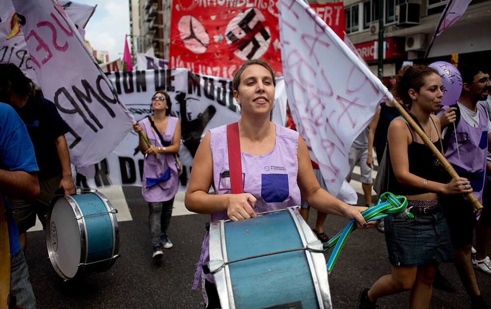 People march protesting the dismissal of workers by the company Kromberg & Schubert, producer of electrical harnesses for Volkswagen and Mercedes Benz, in Buenos Aires, Argentina.