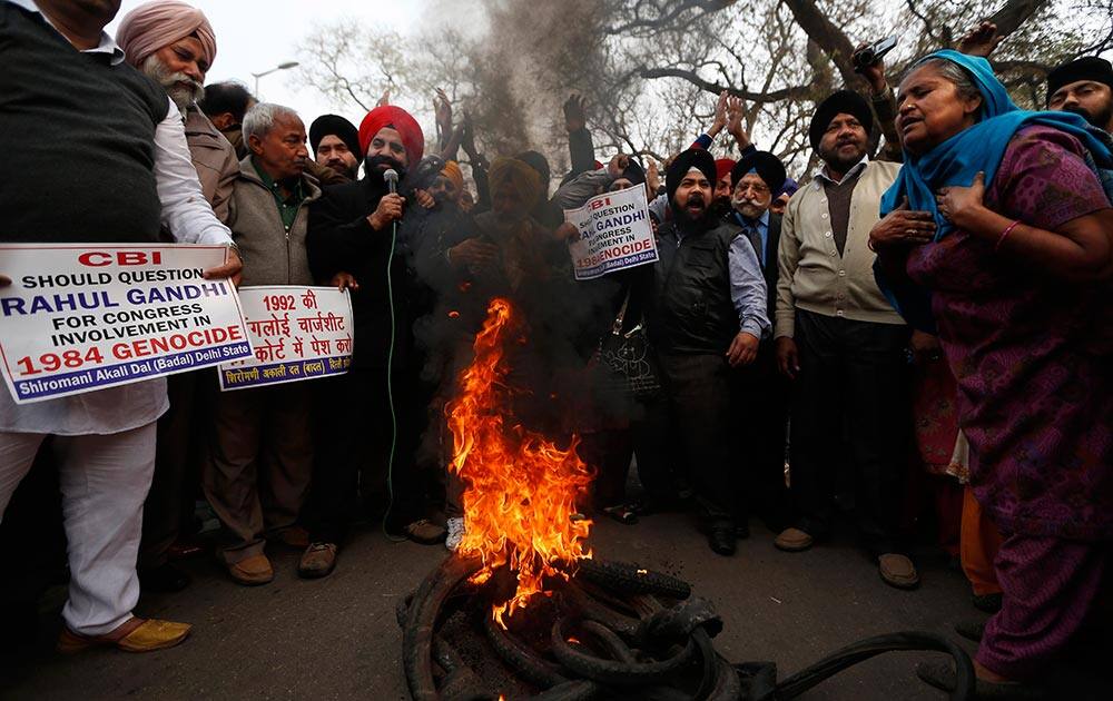 Sikhs burn tires during a protest against Congress party Vice President Rahul Gandhi for his remark on the country`s 1984 anti-Sikh riots in New Delhi.