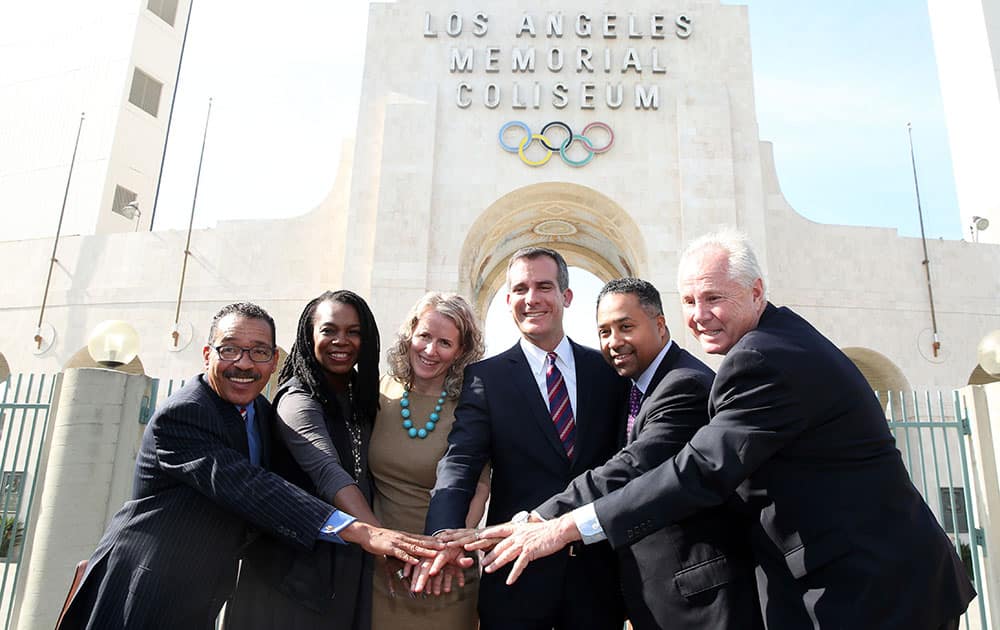 Los Angeles city council president Herb Wesson, Stephanie Hightower, President of USA Track and Field, Tracey Russell, CEO of LA MARATHON LLC, Los Angeles Mayor Eric Garcetti, Max Siegel, CEO of USA Track and Field, and Los Angeles city council member Tom LaBonge pose for a photo after a USATF press conference to announce that Los Angeles will host the Men`s and Women`s 2016 US Olympic Team Trials - Marathon, at the Los Angeles Memorial Coliseum in Los Angeles.