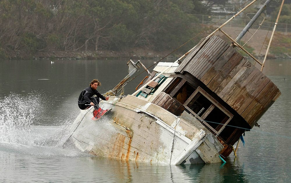 Trever Maur from Santa Cruz, Calif., took advantage of the King high tides on the central coast to wakeboard off the side of a old fishing boat in the Moss Landing Harbor in Moss Landing, Calif.
