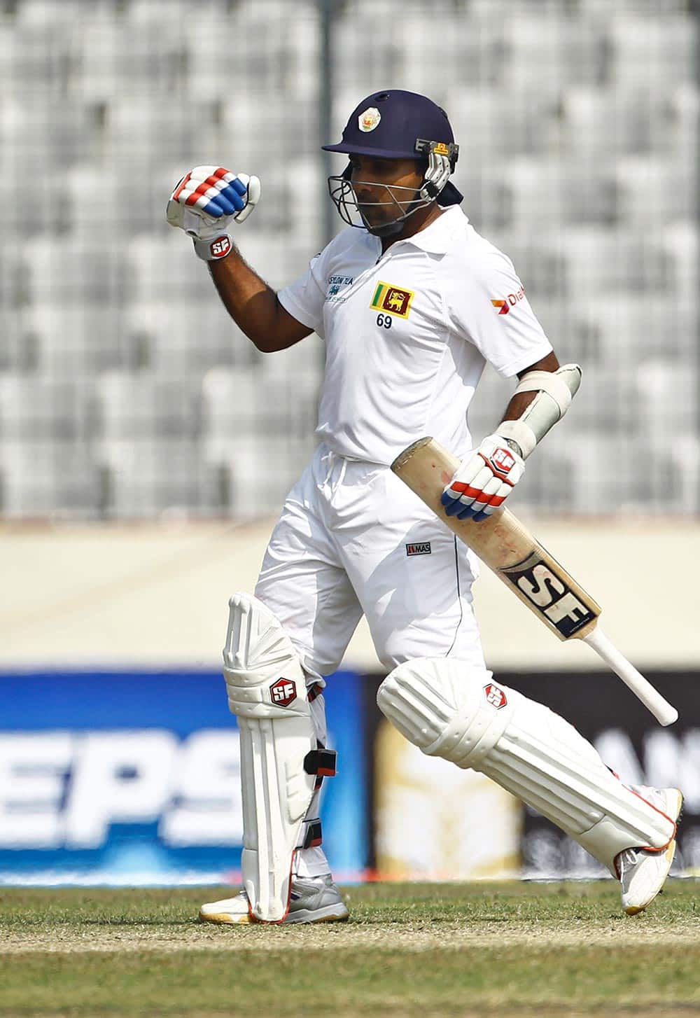 Sri Lanka`s Mahela Jayawardene celebrates after scoring a century on the third day of the first test cricket match against Bangladesh in Dhaka, Bangladesh.