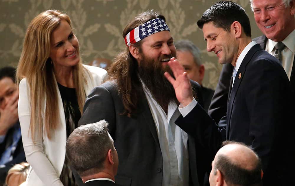 Duck Dynasty`s Willie Robertson, center and his wife Korie, talk with Rep. Paul Ryan, R-Wis., before President Barack Obama`s State of the Union address on Capitol Hill in Washington.