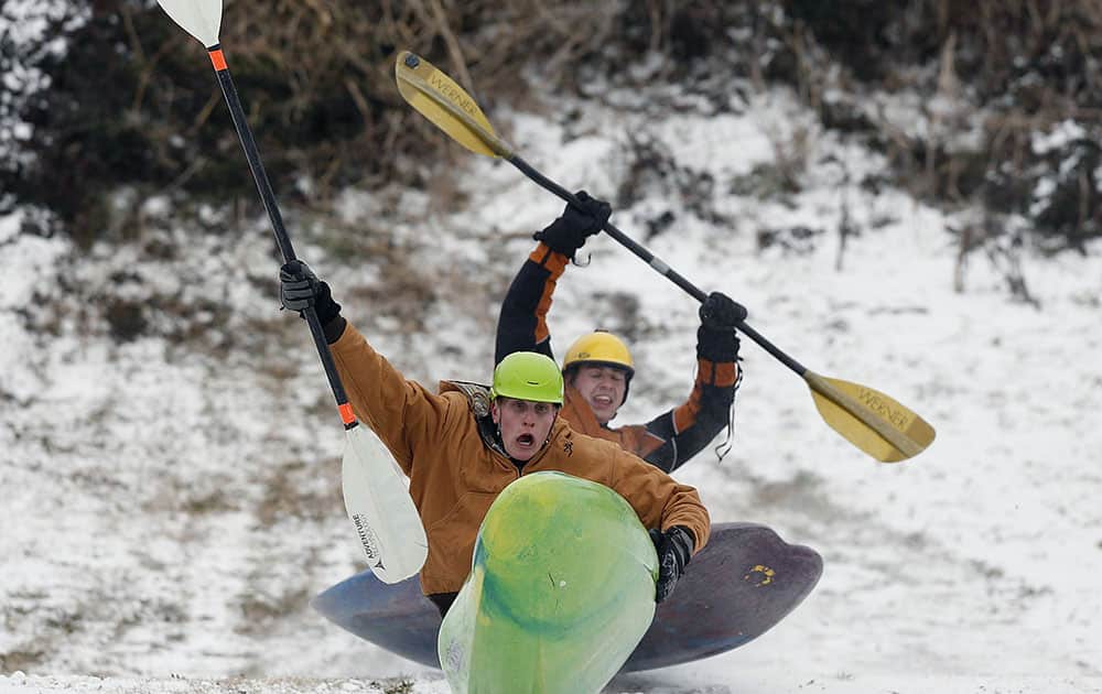 Brent LaForte, front, and Brian Bartlett, rear, grab some air as they slide down a hill in a kayak in downtown Tuscaloosa, Ala.