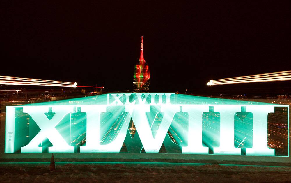 A zoom lens and a long exposure, a sign for NFL football`s Super Bowl XLVIII stands at Pier A Park in Hoboken, N.J.