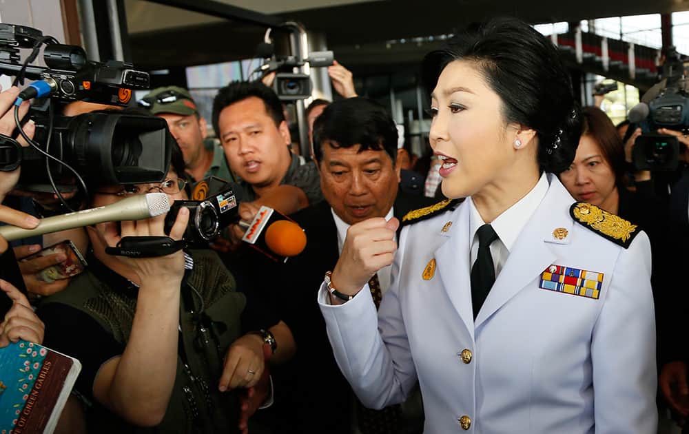 Thailand`s Prime Minister Yingluck Shinawatra speaks to media as she leaves a meeting with election commissioners at the Army Club in Bangkok, Thailand. Thailand`s government announced Tuesday it will go ahead with an election this weekend despite months of street protests and an opposition boycott.