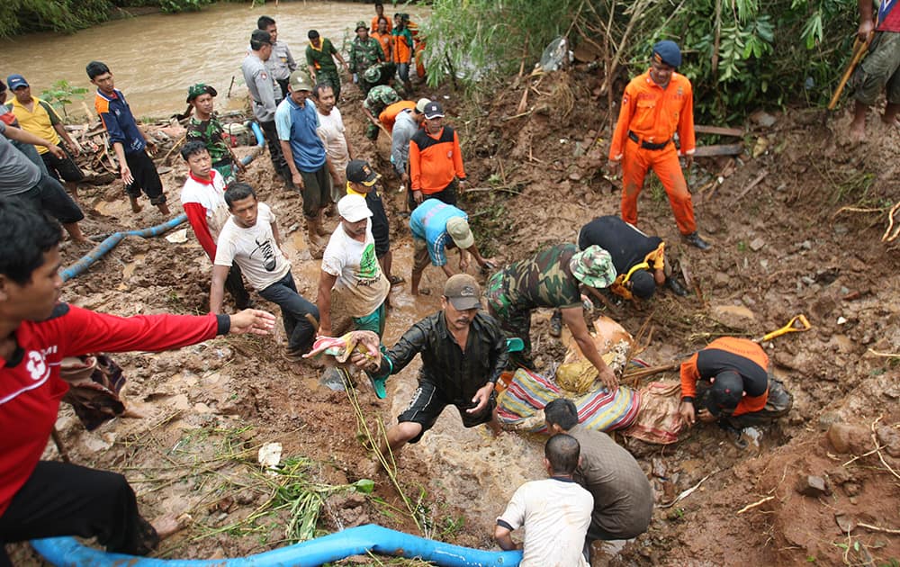 Rescuers search for the victims of a landslide in Jombang, East Java, Indonesia. Two landslides triggered by torrential rain killed more than a dozen of people and left some others missing on Indonesia`s main island of Java, a government official said Tuesday.