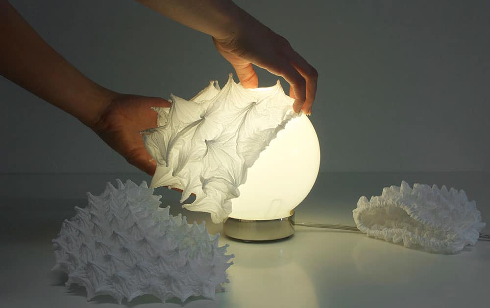 This photo provided by Suzusan shows shibori lamp shades by Hiroyuki Murase, creative director at the Dusseldorf-based Suzusan and the 5th generation of a shibori-making family, that exemplifies both the 3-D possibilities of shibori and the bridge between traditional and new.