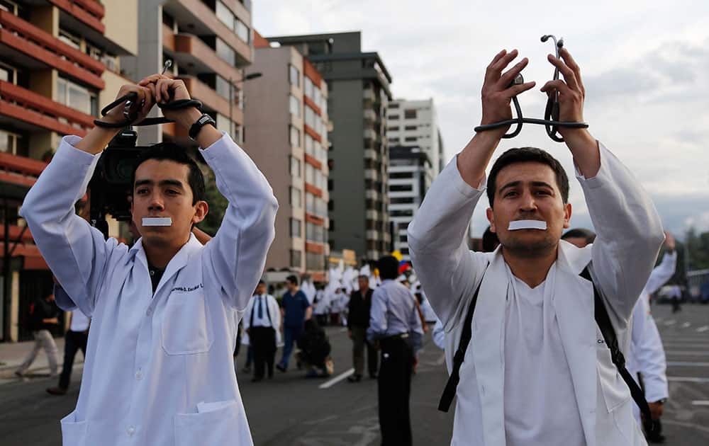 Doctors and medical students protest against a new law criminalizing medical malpractice in Quito, Ecuador.